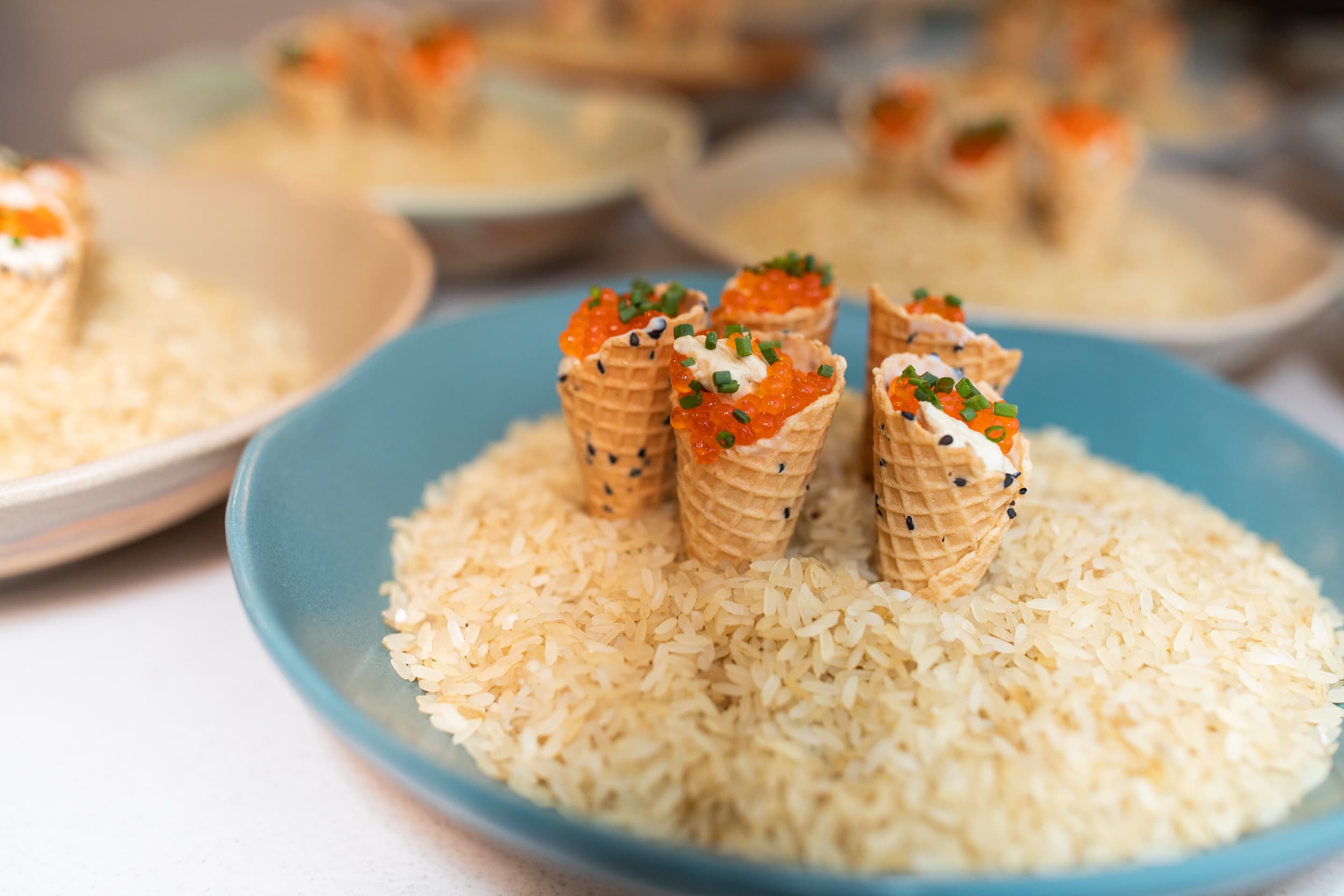 Salmon caviar cones served in rice — amuse-bouche