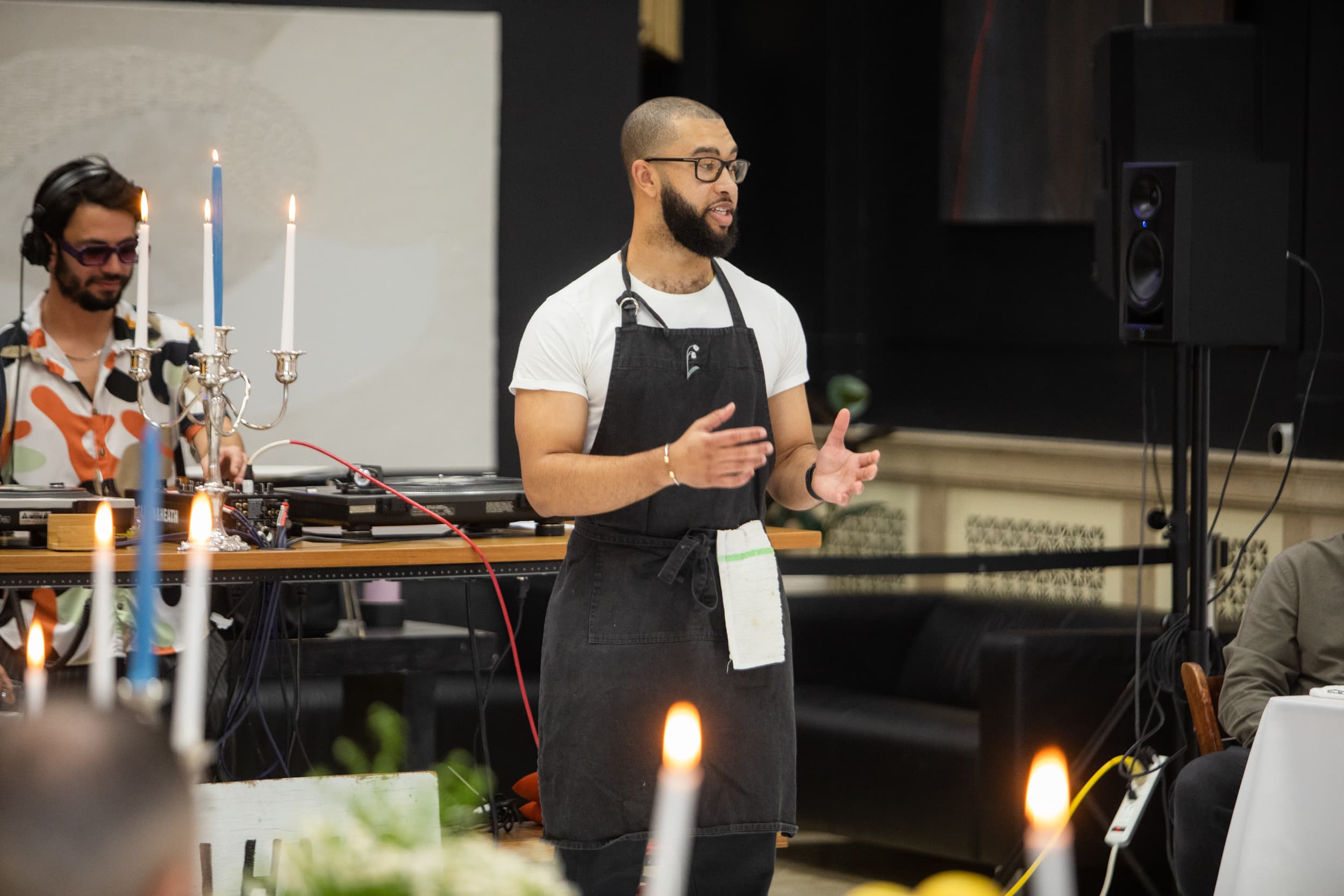 Chef Marcel addressing guests at the table