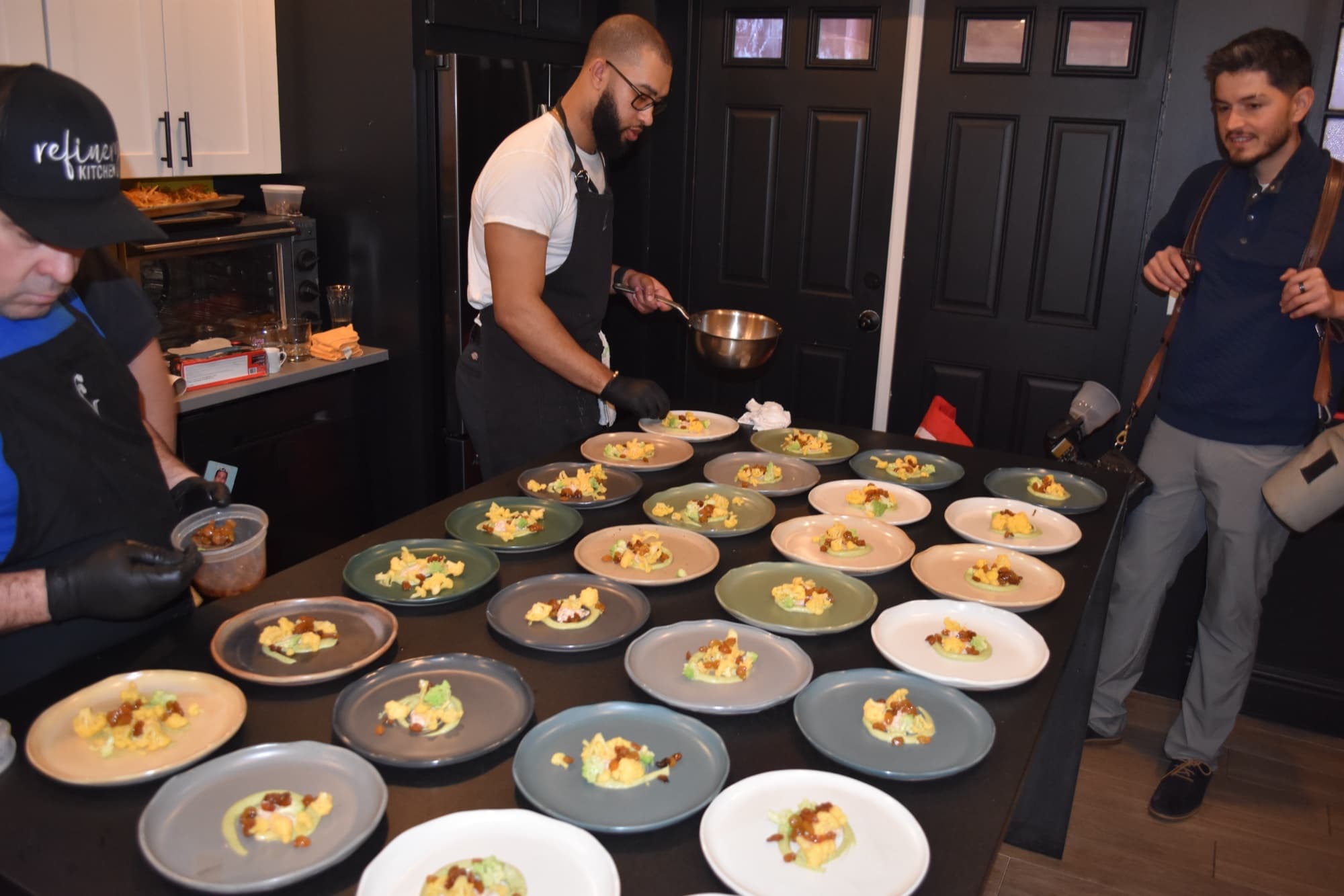 Kitchen in full swing — plating 20+ covers