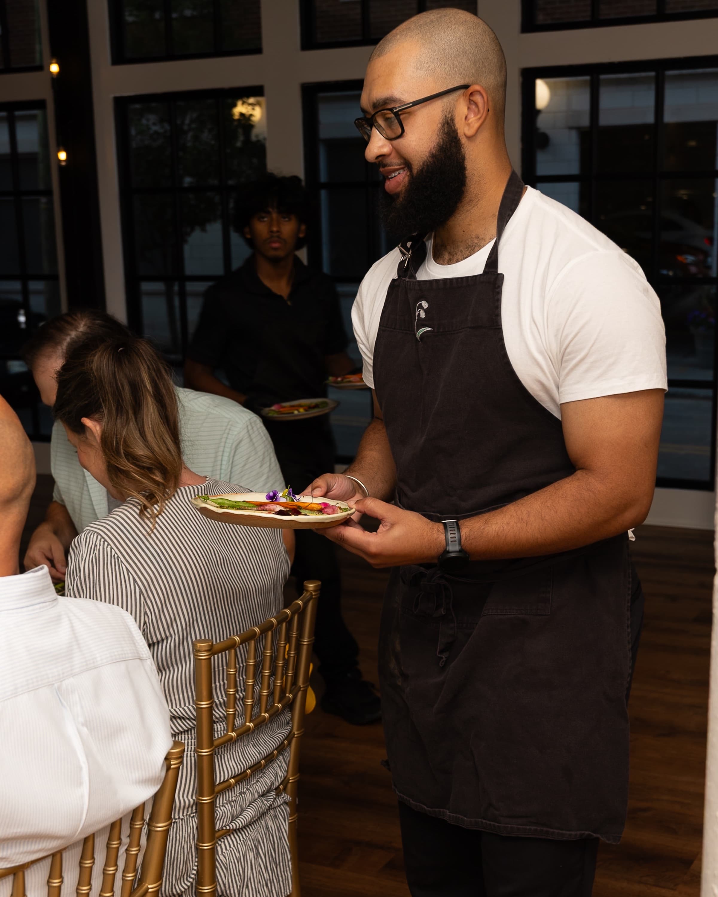 Chef Marcel serving a guest