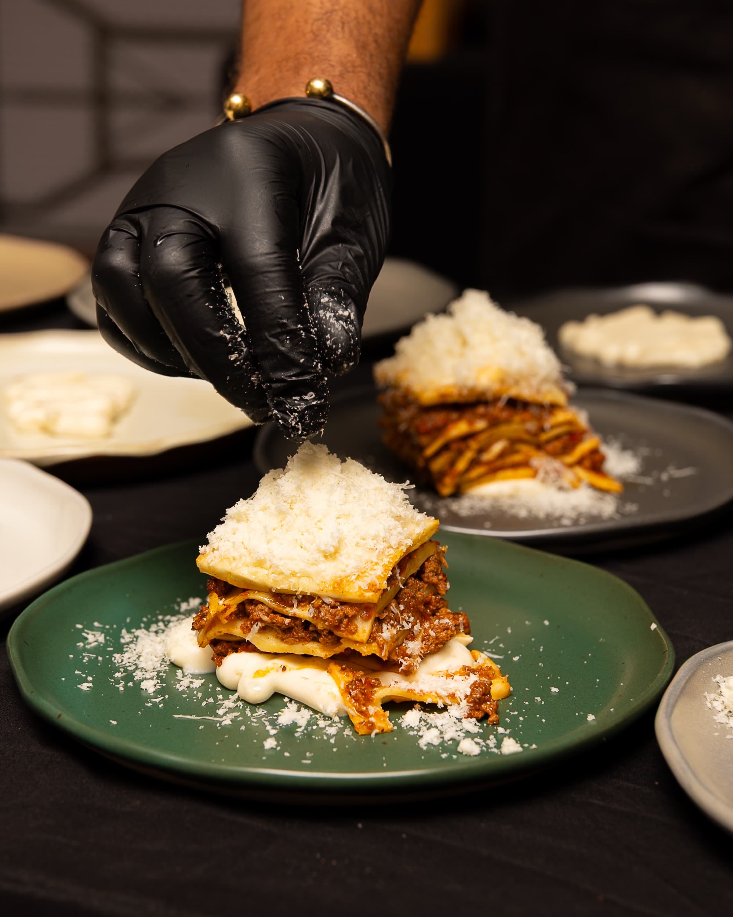 Lasagna Alla Fiamma — finishing with aged cheese tableside